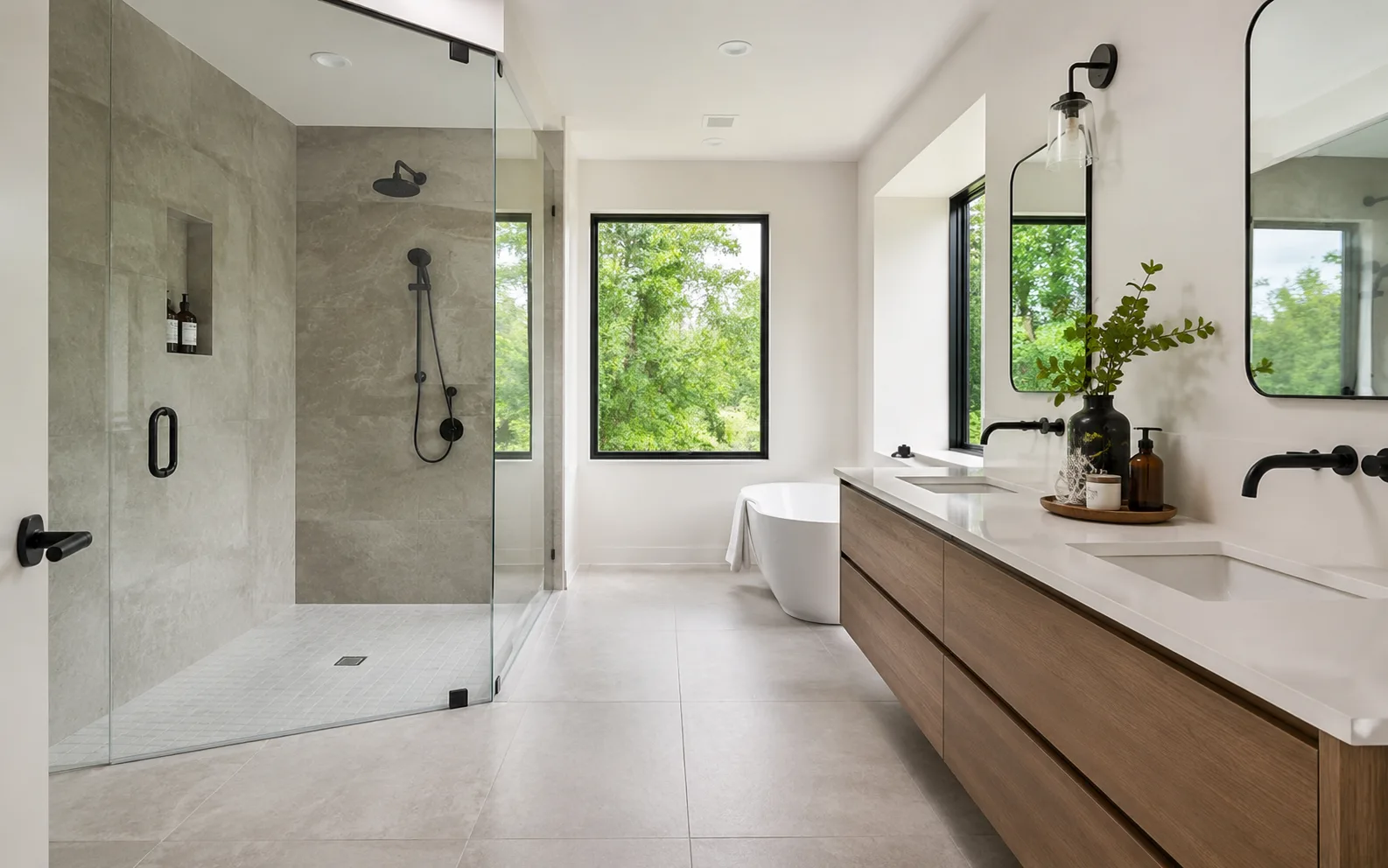 Finished primary bathroom with a glass walk-in shower, freestanding tub, and double vanity